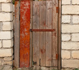 Wooden door with old door lock brick wall.