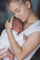 Portrait of mother and her newborn baby.