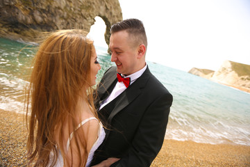 Groom and bride near the sea
