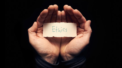 Hands holding a Business Ethics Concept - obrazy, fototapety, plakaty
