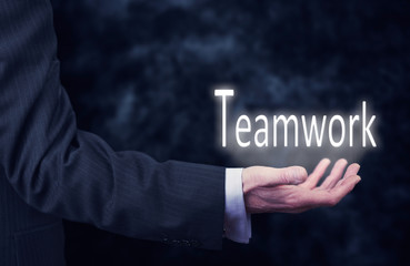 Hand holding a Teamwork Concept