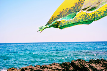 Parasol on a windy day at the beach in summer