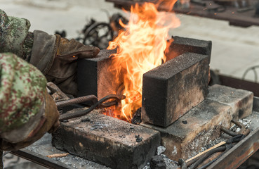 blacksmith makes horseshoe by tools