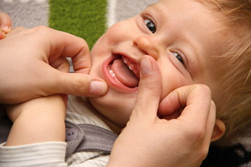 Smiling boy with first deciduous teeth - obrazy, fototapety, plakaty
