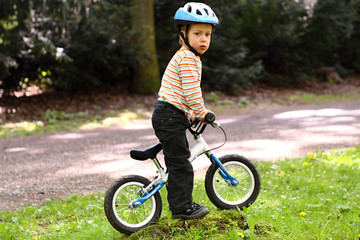 Boy on the small bicycle without pedals