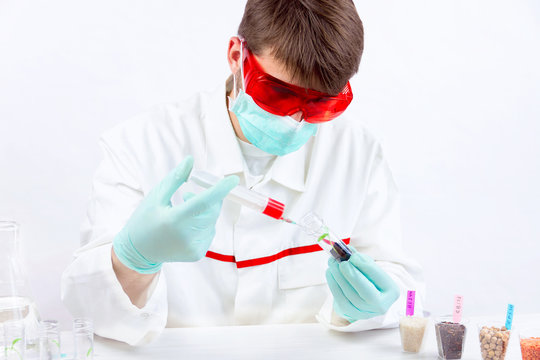 Chemistry researcher observing indicator color shift of gmo food