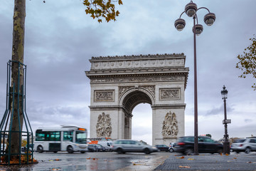 Fototapeta na wymiar Triumphal arch. Arc de triomphe. View of Place Charles de Gaulle. Famous touristic architecture landmark in rainy day. Long exposure photography. Paris. France.