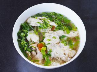 Bowl of soft boiled rice with pork and egg