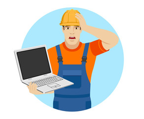 Builder with laptop grabbed his head