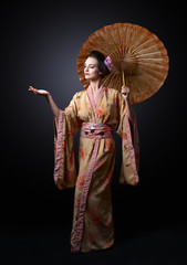 beautiful woman in traditional Japanese kimono with umbrella