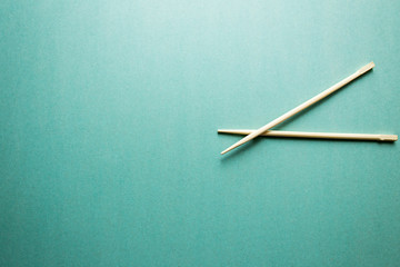 two Chinese chopsticks on the aqua background
