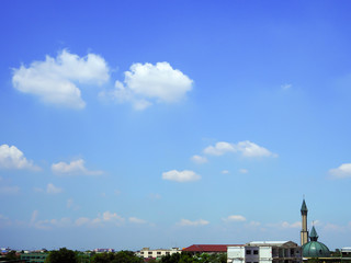 Cloudy sky background with ancient muslim mosque in residential area