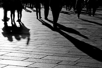 Shadows of people walking in the city