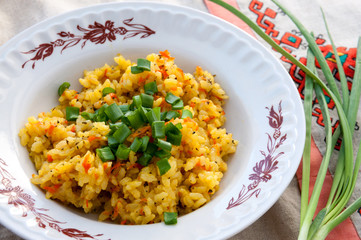 Plate of pilaf with green onions for lunch