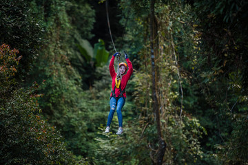 Woman going on a jungle zip line adventure, asia