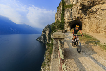 Fototapeta premium Mountain biking on Lake Garda, Sentiero della Ponale, Riva del Garda, Italy