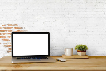 Mock up Blank Screen Laptop on wood table and white brick wall.