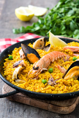 Traditional spanish seafood paella on wooden background
