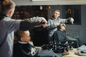 Little Boy Getting Haircut By Barber  