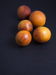 Blood oranges isolated on black background