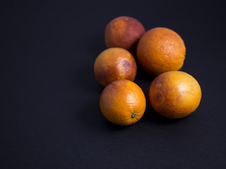 Blood oranges isolated on black background