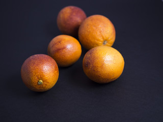 Blood oranges isolated on black background