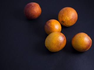 Blood oranges isolated on black background