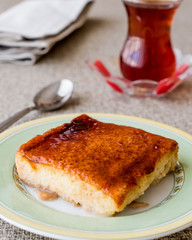 Balkan Dessert Cake Trilece with caramel sauce and tea.