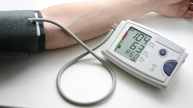 A man is measuring blood pressure and heart-rate