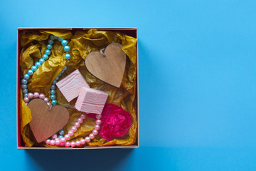 The craft gift box with the heartcard and sweets on the blue background