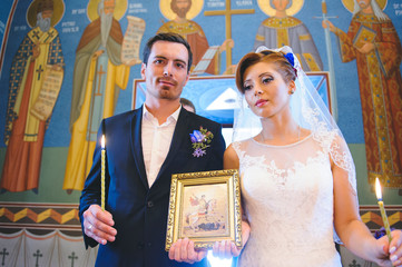 Newlyweds with Icon and Candles