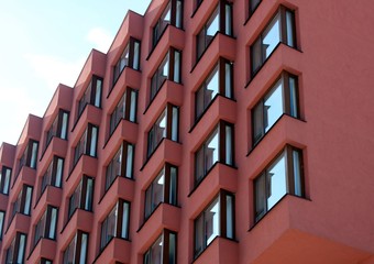 The photo of a facade with symmetrically arranged windows.
