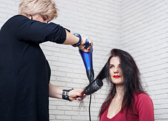 drying hair with hair dryer and round brush © alter_photo