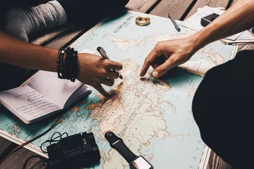 Foto op Canvas Couple planning vacation using the world map. © Jacob Lund