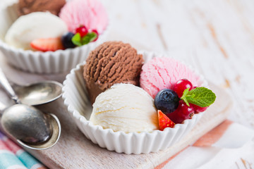 Selection of colorful ice cream scoops in white bowls