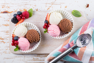 Selection of colorful ice cream scoops in white bowls