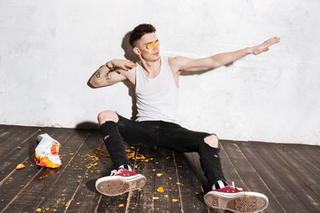 Man putting potato chips on his eyes and having fun