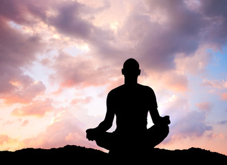 man practicing yoga outdoors