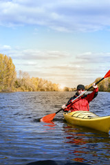 Traveling by kayak on the river on a sunny day.