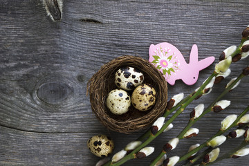 Easter eggs and willow branches on wooden desk. Easter background.