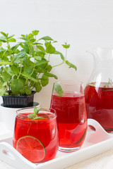 Fresh red berry drink in glass. White background. Copy space.