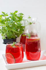 Fresh red berry drink in glass. White background. Copy space.