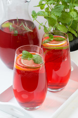 Fresh red berry drink in glass. White background. Copy space.