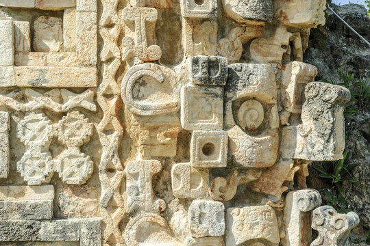 detail of the reliefs and large masks of the god Chaac of the temple of the big Mayan pyramid in the archaeological Uxmal enclosure in yucatan, Mexico
