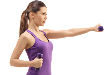 Profile shot of a woman exercising with dumbbells