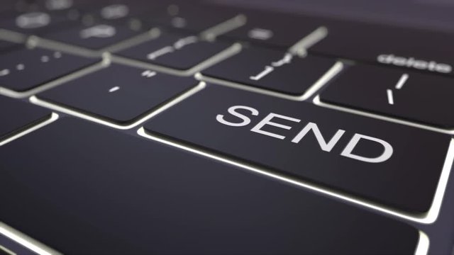 Tracking shot of modern black computer keyboard and luminous send key. Conceptual 4K clip