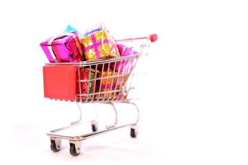 Shopping Cart with Christmas or New Year gifts boxes on isolated white