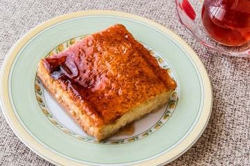 Balkan Dessert Cake Trilece with caramel sauce and tea.