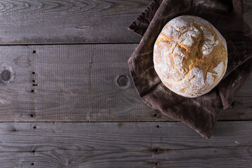 Freshly baked traditional bread on wooden table