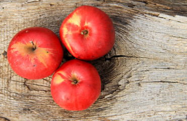 Red apples on wooden background